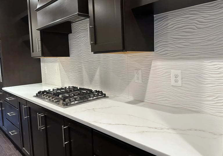 Textured white wave backsplash tile installed behind gas cooktop and quartz.