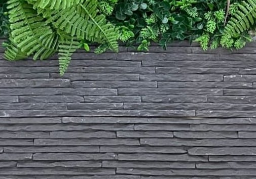a man in a suit and tie standing on a wooden deck