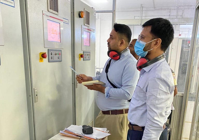 Energy auditor is checking the data of electrical power generation of a generator from the panel.