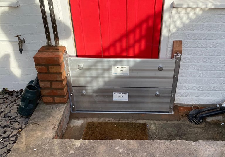 a red door fitted with flood defence barrier