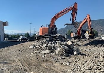 Two excavators sorting and crushing concrete