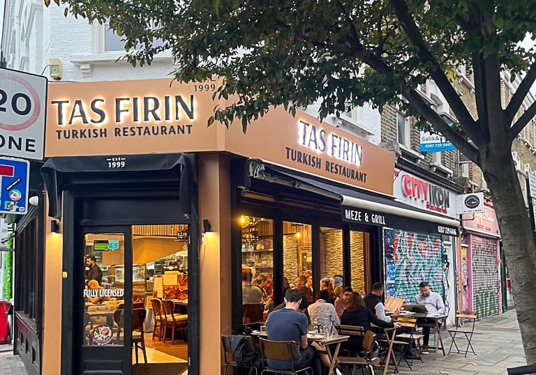 a restaurant with a bicycle parked in front of a tree