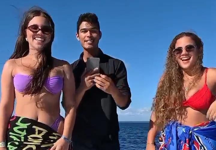 a group of people standing on a boat