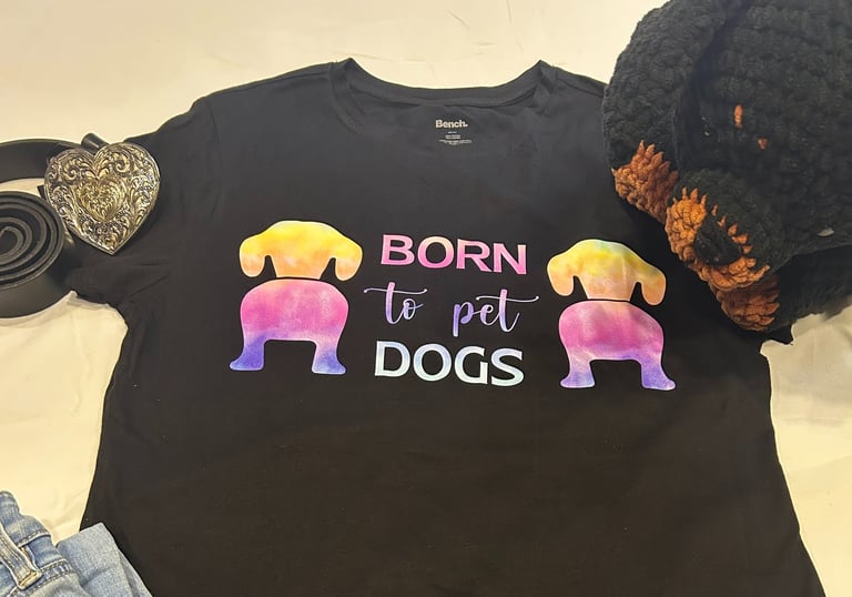 a tshirt that says "born to pet dogs" paired with a belt and jeans along with a stuffed rottweiler