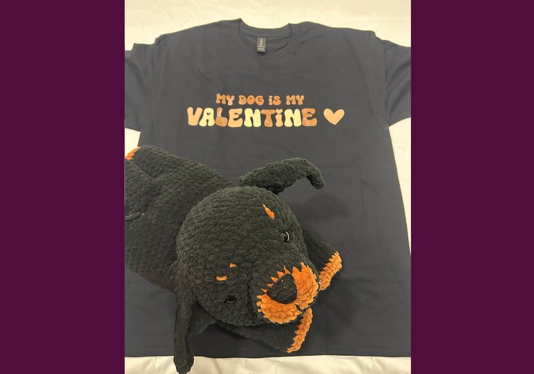 a tshirt that says "my dog is my valentine" with a stuffed rottweiler on top of it
