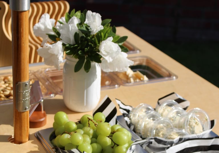 Fruit and cheese on a bar cart with flowers