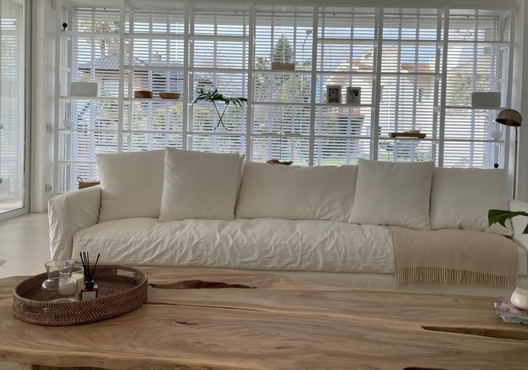 a living room with a couch and a wooden table