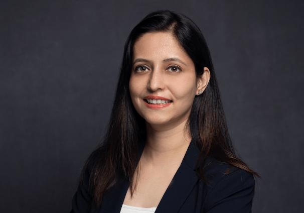 Dr Anam in a black suit and white top