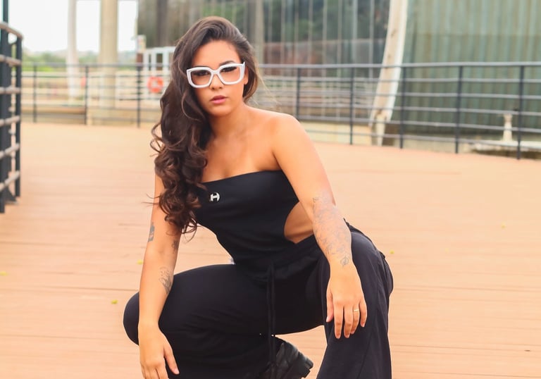 a woman in a black top and sunglasses