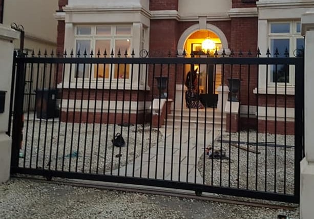 a large house with a gated in area with a gate