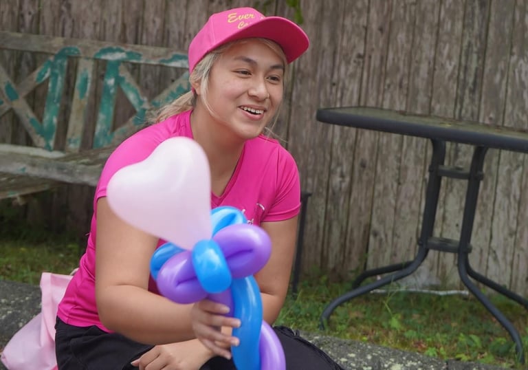 Handing a balloon to a child
