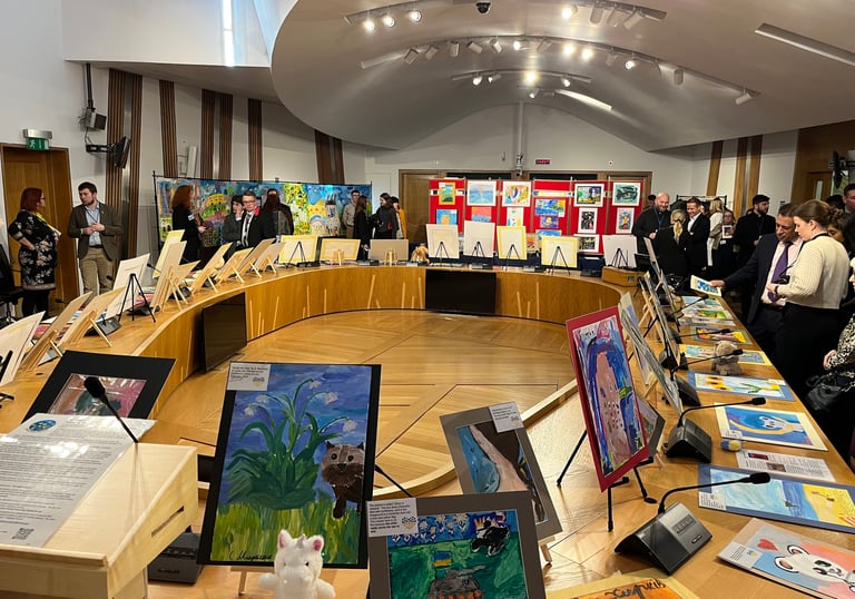 Politicians looking at the exposition with paintings created by children in the Ukrainian war