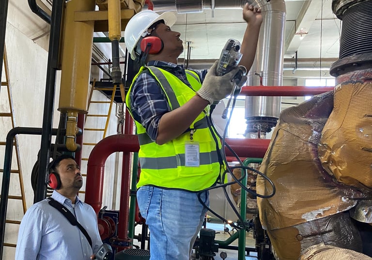 SREDA-certified energy auditor conducting flue gas analysis of a generator to measure efficiency.