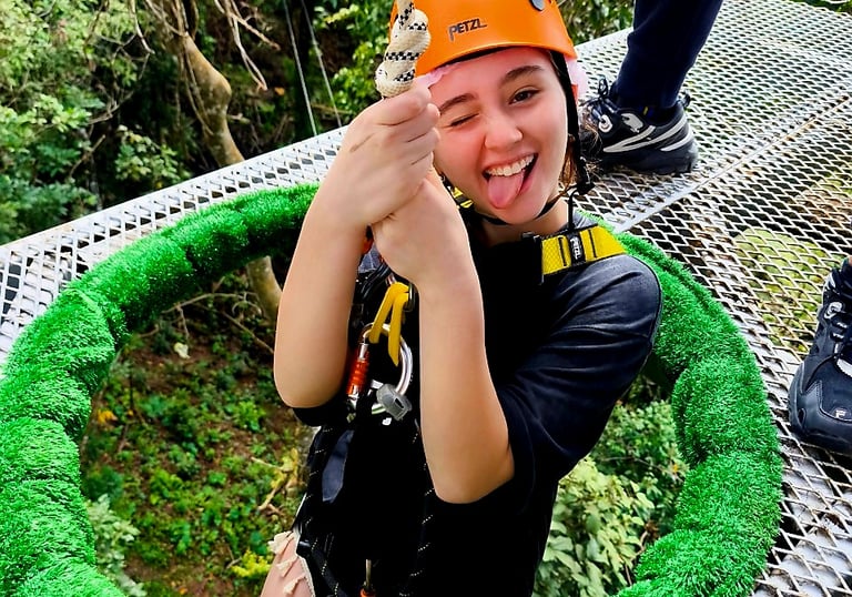 a woman in a helmet and helmet on a rope - zipline adventure park koh samui