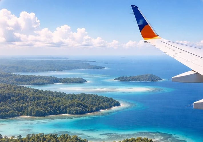Andaman trip details - Aerial window view of lush tropical islands and coral reefs in the turquoise 