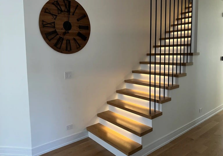 Modern floating oak staircase renovation with LED under-lighting and custom black metal railings