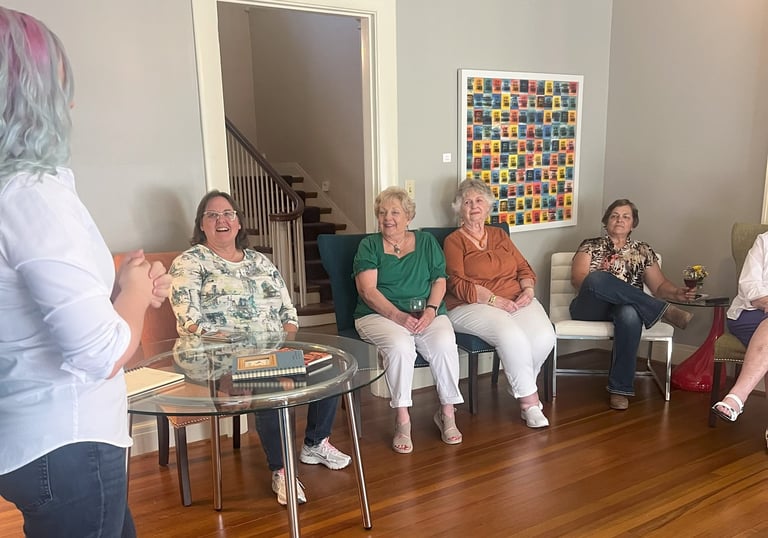 Tabitha with butterfly effect consulting talking to a group of clients at Main Street House
