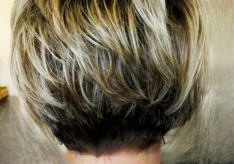 a woman with a short blonde haircut and a short blonde bobble