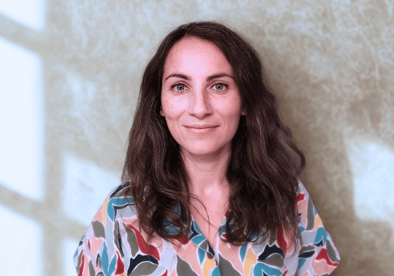 a woman in a colorful shirt and jeans