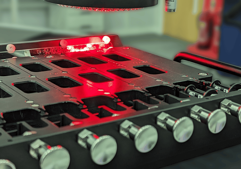 Multi-nest metrology fixture holding small thin medical devices whilst being inspected by an optical CMM.