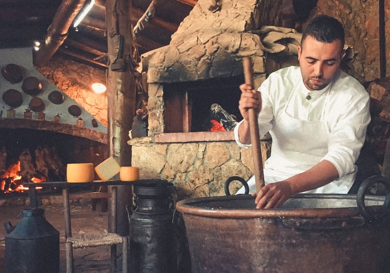 Man making traditional cheese in copper pot, Sardinia food culture