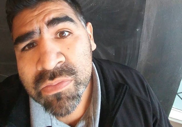 Joke Daddy standing in front of a chalkboard