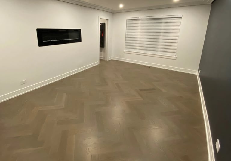 Custom herringbone hardwood flooring installation with modern fireplace in a Chicago North Shore home