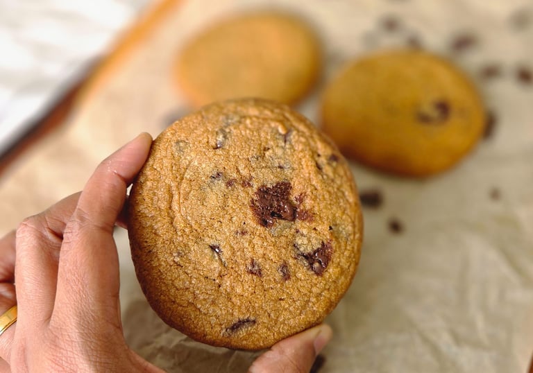 a person holding a cookie cookie cookie on a table