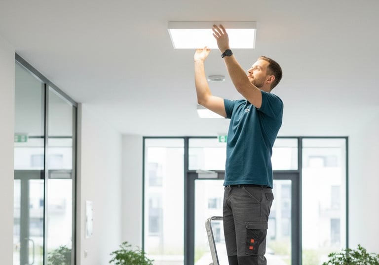 a man standing on a ladder ladder to reach the ceiling