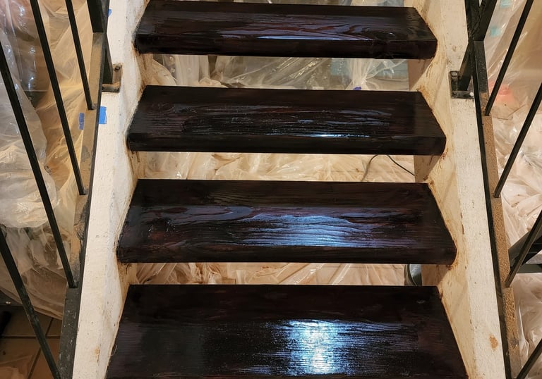 a staircase cased in a plastic bag stained wood stairs