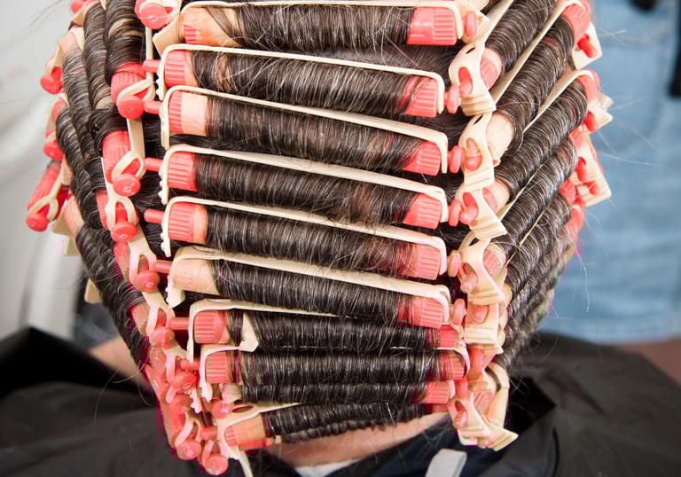 Stylist applying perm solution - Ladies permanent wave services Brookfield Illinois