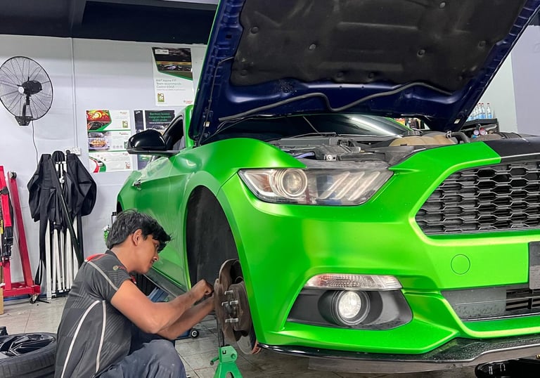 a man working on a car in a garage
