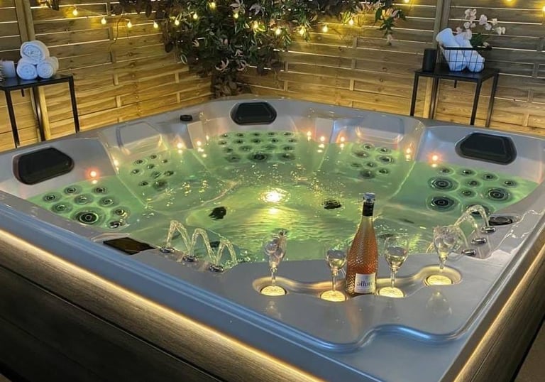 a hot tub with candles and candles on a patio