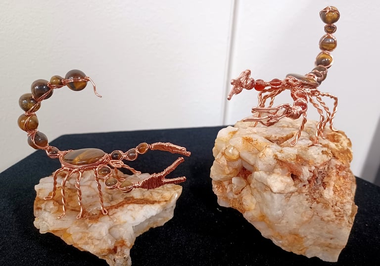 Wire wrap scorpion sculptures: copper, tiger's eye, and fire agate.