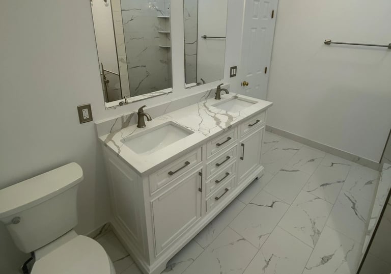 Modern bathroom with white double vanity and bronze faucets