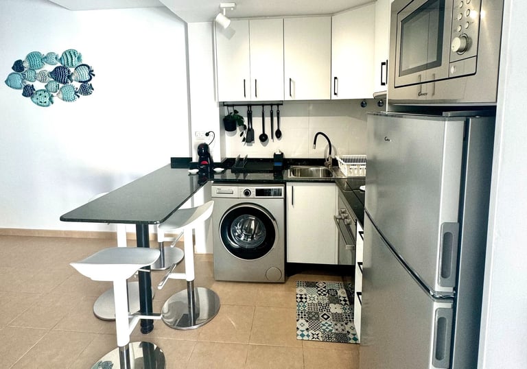 a kitchen with a washing machine and a washing machine