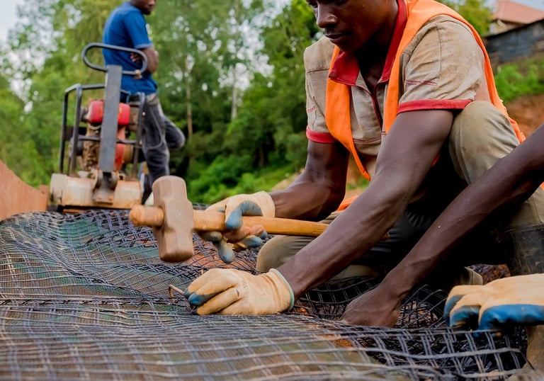 Close-up of geogrid reinforcement being installed for soil stabilization.