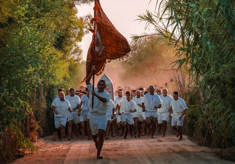 Barefoot runners in white during Corsa degli Scalzi religious tradition, Cabras, Sardinia.