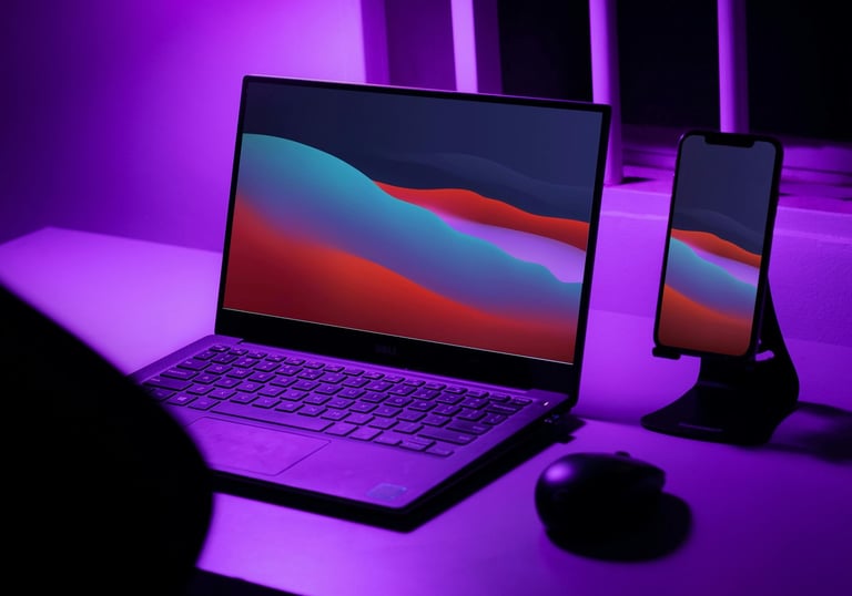 a laptop computer sitting on a desk with a purple light