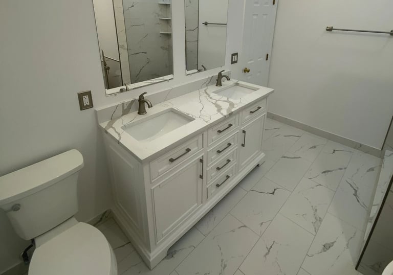 Modern bathroom with white double vanity and bronze faucets