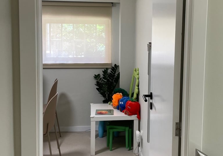 a hallway way with a table and chairs