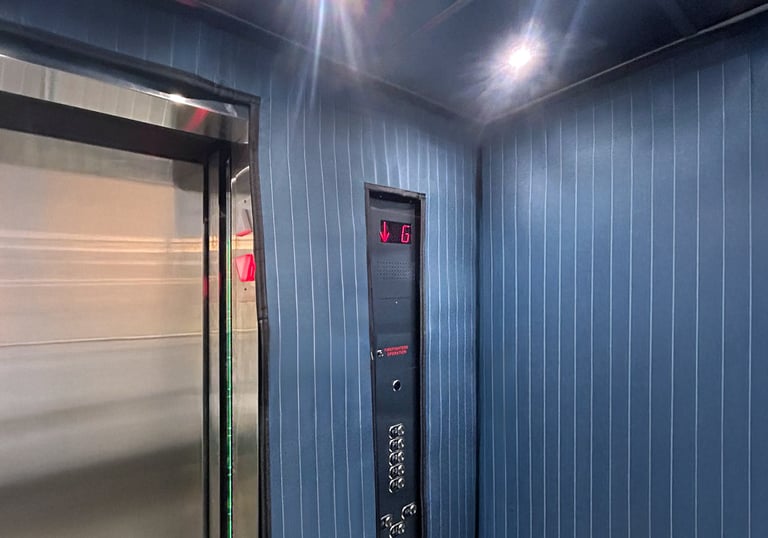 elevator interior with protection pads installed to protect the walls during moves