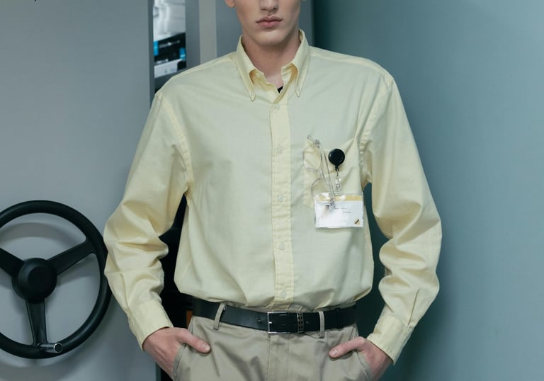 a man in a yellow shirt and khaki pants