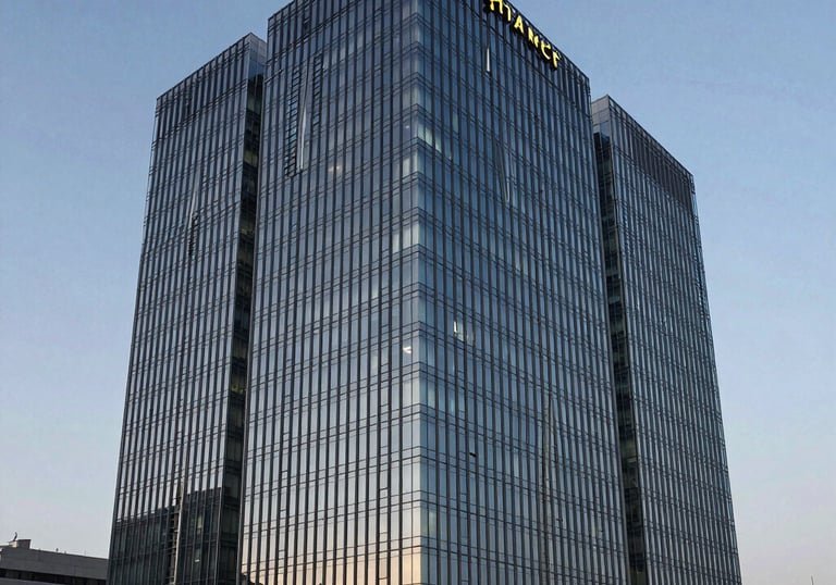 Modern architectural shot of a sleek glass business center in Almaty during twilight, symbolizing corporate stability and innovation in Kazakhstan.