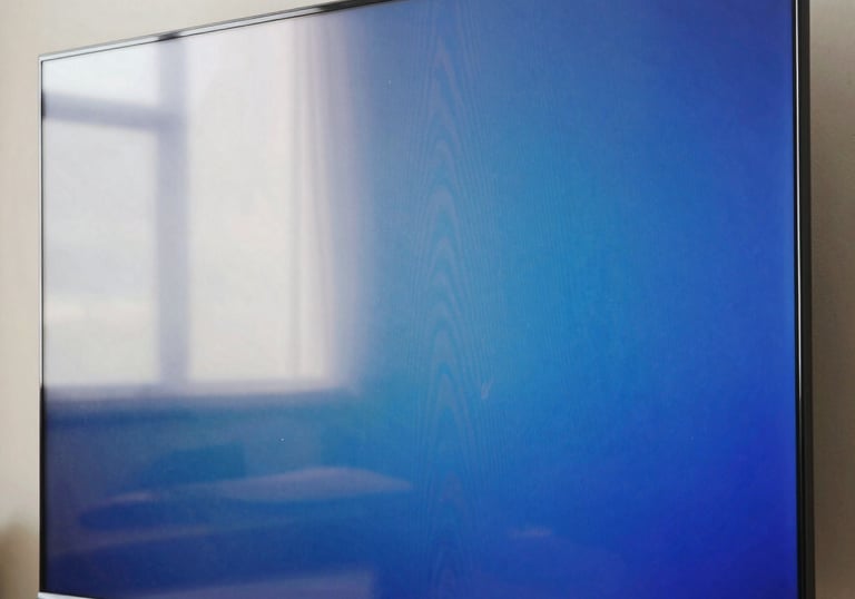 A close-up of a vibrant Smart TV screen showing deep blue and off-white colors, highlighting the clear resolution after professional repair.