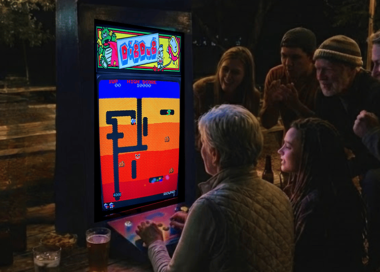 a group of older people playing Dig Dug on a Retro Arcade Game Slab.