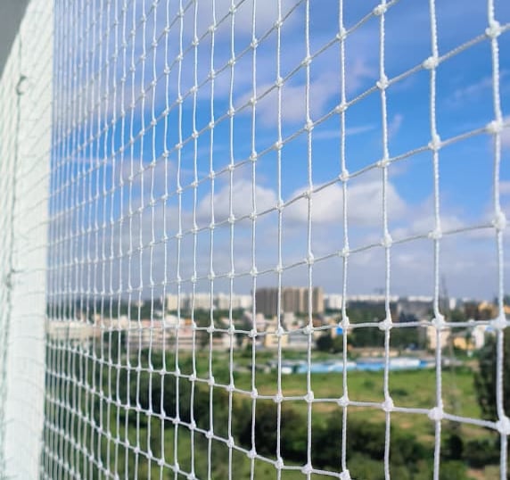 A bright, safe balcony protected by a freshly installed child safety net in Electronic City.