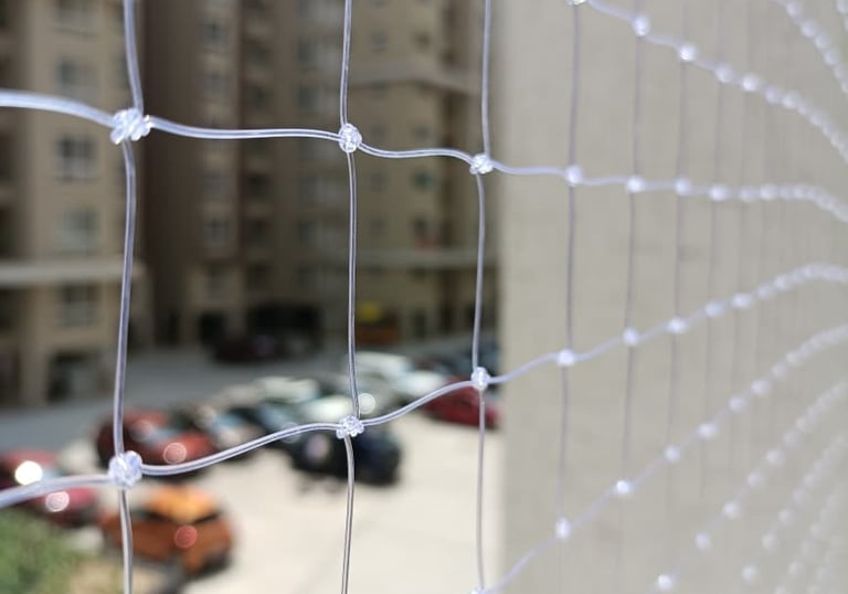Close-up of a sturdy balcony safety net securely fastened.