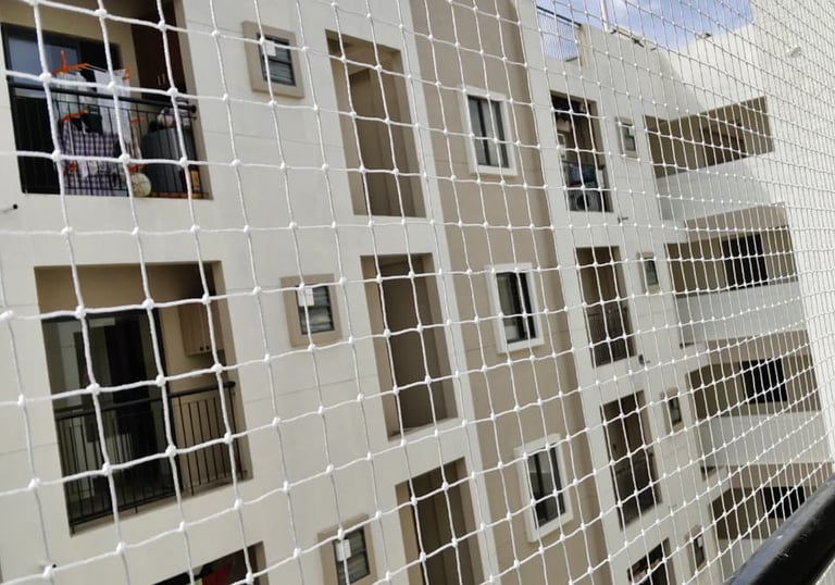 Technician carefully measuring a balcony for pigeon net installation.