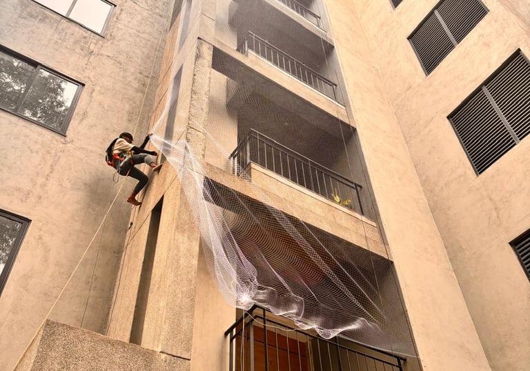 Wide shot of a residential building in Bengaluru secured with pigeon safety nets.